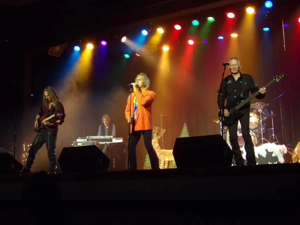 Full band performing with colorful concert lights
